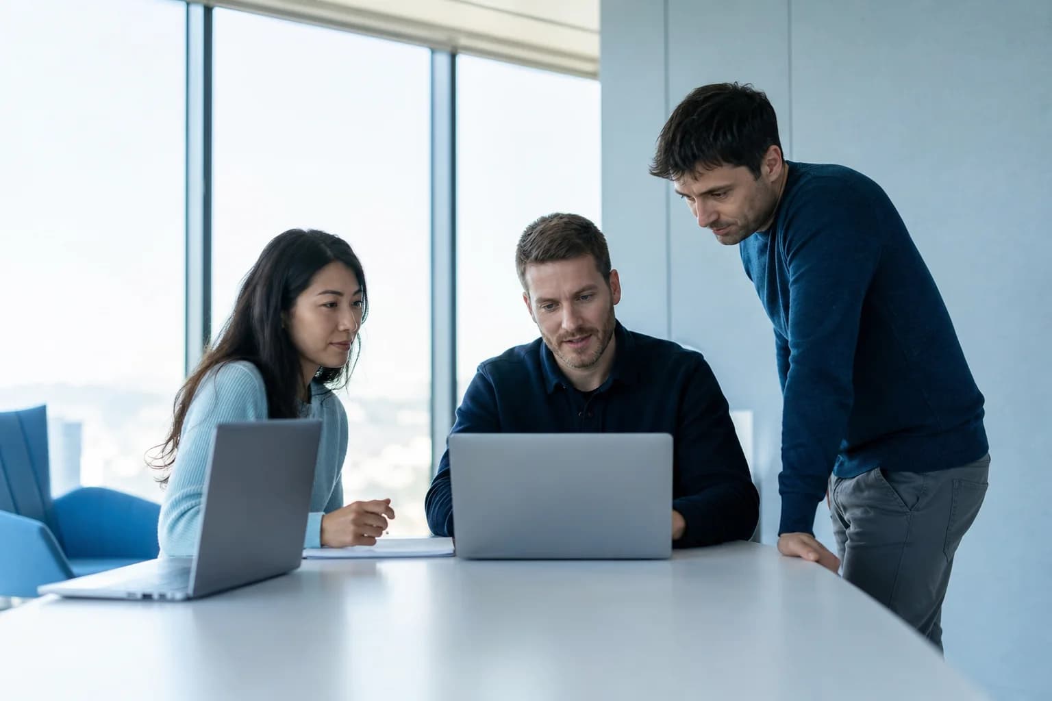 Engineering leaders comparing developer hiring platforms in a modern office.